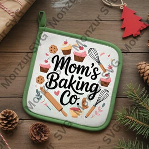 May include: A square, white pot holder with a green border and a hanging loop. The pot holder features the text "Mom's Baking Co." with illustrations of cupcakes, cookies, a rolling pin, and a whisk. The background includes pinecones and a red Christmas tree ornament.