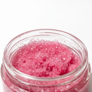 May include: A set of three ceramic canisters with lids. The canisters are white with a blue floral pattern. The largest canister is 8 inches tall, the medium is 7 inches, and the smallest is 6 inches.