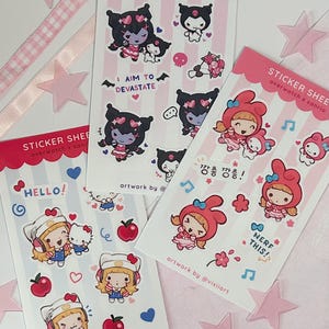 May include: Three sticker sheets featuring Overwatch and Sanrio character mashups. The sheets display cartoon figures like Kuromi, My Melody, and Hello Kitty with text including I AIM TO DEVASTATE, HELLO, NERF THIS, and Korean characters.