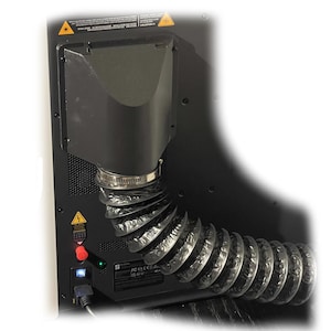 May include: A black machine component with a flexible, corrugated tube attached. The component has a rectangular vent and a metal clamp securing the tube. Warning symbols and a power button are visible.