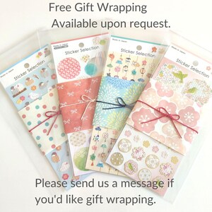 May include: Four clear plastic sleeves containing Sticker Selection sheets. Each sheet features various Japanese-inspired patterns, including birds, floral motifs, and geometric shapes, secured with colored string ties and paper bands.