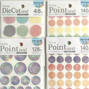 May include: Four packs of translucent tracing stickers. Top left: DieCut seal with irregular shapes in pastel colours. Top right: Point seal with solid pastel circles. Bottom left: Point seal with iridescent bubble designs. Bottom right: Point seal with watercolour-style circles.