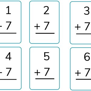 May include: Six white flashcards with blue borders, each displaying a simple addition problem. The numbers 1 through 6 are each added to 7. The problems are written in black, with the answer line below.