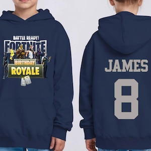 May include: Navy blue Fortnite-themed hoodie with the text "BATTLE READY! FORTNITE BIRTHDAY ROYALE" on the front. The back features the name "JAMES" and the number "8" in gray.