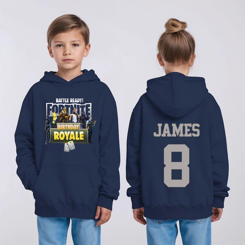 May include: Navy blue Fortnite-themed hoodie with the text "BATTLE READY! FORTNITE BIRTHDAY ROYALE" on the front. The back features the name "JAMES" and the number "8" in gray.