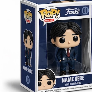 May include: A Funko Pop! Real Life vinyl bobble-head figure in a display box. The figure has black hair, a dark blue suit, and a red tie. The box features the text Pop! Real Life, Funko, 01, and Name Here. The packaging includes a warning label.