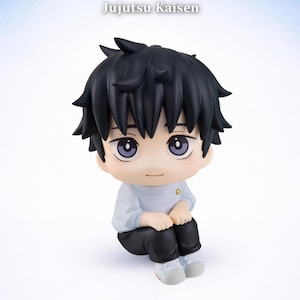 May include: A Jujutsu Kaisen Yuta Okkotsu figure. The figure has black hair, a light blue shirt, and black pants. The figure is sitting down with its hands clasped. The text "Jujutsu Kaisen" and "Yuta Okkotsu" are visible.