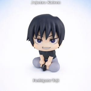 May include: A Jujutsu Kaisen Fushiguro Toji figurine. The figure has black hair and is wearing a black shirt and gray pants. The text "Jujutsu Kaisen" and "Fushiguro Toji" are visible. The Kawaii Desu logo is in the bottom left corner.