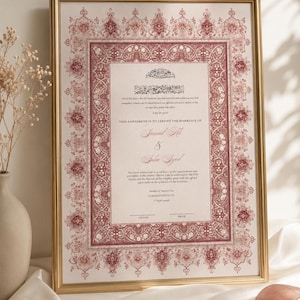 Peut inclure: Un certificat de mariage islamique encadré avec une bordure florale décorative rouge et blanche. Le document comprend une calligraphie arabe en haut, le texte anglais THIS AGREEMENT IS TO CERTIFY THE MARRIAGE OF et des lignes pour signatures.