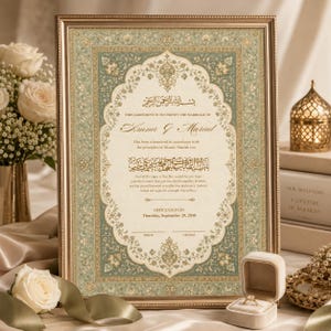 May include: A framed Islamic marriage certificate featuring intricate sage green and gold floral borders, elegant calligraphy, and printed text stating the marriage of Amna and Murad, dated September 29, 2030, with blank lines for signatures.