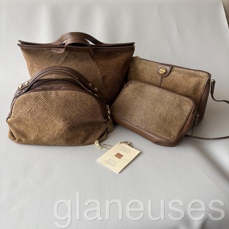 May include: A collection of brown leather handbags and purses. The bags vary in size and style, including a tote, a satchel, and a crossbody bag. The leather has a textured appearance. A tag is attached to one of the bags.
