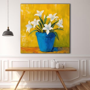 May include: A square canvas painting depicts white lilies in a blue pot against a yellow background. The flowers have green leaves and are arranged in a vibrant display. The artwork is a still life with a textured, painterly style.