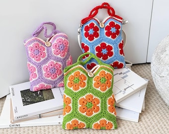 May include: Three handmade crochet bags featuring a hexagonal floral pattern. One bag is purple and pink, one is red and blue, and one is green and orange. Each bag has a single wooden button closure and a matching crochet handle.