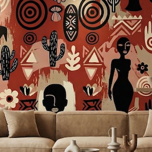 May include: A beige sectional sofa sits before a wall covered in wallpaper featuring a repeating pattern of black silhouettes of human figures, hands, cacti, flowers, and geometric shapes against a textured terracotta and cream background.
