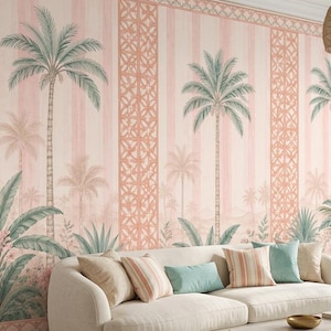 May include: A light beige sofa with assorted throw pillows sits before a wall covered in wallpaper featuring a repeating pattern of palm trees, vertical stripes, and geometric lattice designs in shades of soft pink, peach, and muted green.