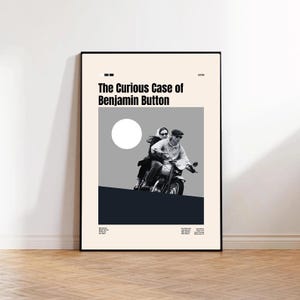 May include: A framed poster for "The Curious Case of Benjamin Button." The poster shows a black and white image of two people on a motorcycle. The background is a mix of grey, white, and navy blue. The title is in bold, black text.