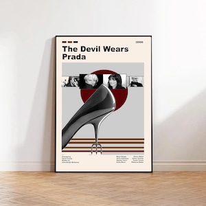 May include: A framed movie poster for "The Devil Wears Prada" featuring a high-heeled shoe, images of the cast, and the film's title. The poster has a minimalist design with a neutral color palette and the year 2006.
