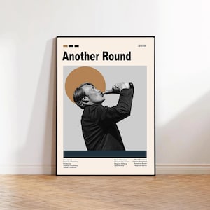 May include: A framed poster for the film "Another Round" featuring a black and white image of a man drinking from a bottle. The poster has a beige background with the film title in bold black letters and a brown circle.