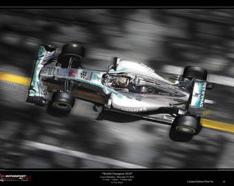 May include: A silver and blue Formula 1 race car with the words "Petronas" and "World Champion 2014" on the side. The car is in motion, creating a blur effect.