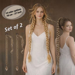 May include: Set of two long, blonde braided hair extensions, each approximately 27 inches (70 cm) long. The image shows a woman with long blonde hair, wearing a white dress, and the extensions. Text indicates 14 color options.