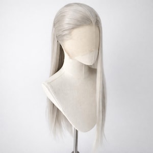 May include: A long, silver-grey wig with a natural-looking hairline is displayed on a mannequin head. The wig features straight, flowing hair, and a lace front for a realistic appearance. The wig is designed for cosplay or costume use.