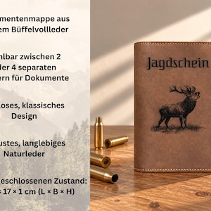 May include: A brown leather document holder featuring an embossed stag and the text "Jagdschein" on the front cover. Three brass-colored metallic bullet casings are positioned to the left of the holder, which measures 12 x 17 x 1 cm.