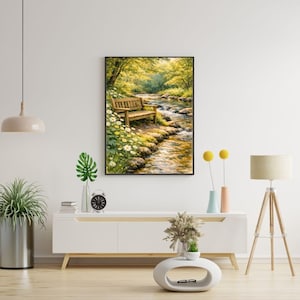 May include: A framed landscape painting depicts a serene outdoor scene. A wooden bench sits near a flowing stream, surrounded by lush greenery and yellow flowers. The artwork captures a peaceful, natural setting.