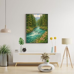 May include: A framed landscape painting depicts a river flowing through a forest. The water is turquoise, surrounded by green trees and pink flowers. Mountains are visible in the background under a blue sky.