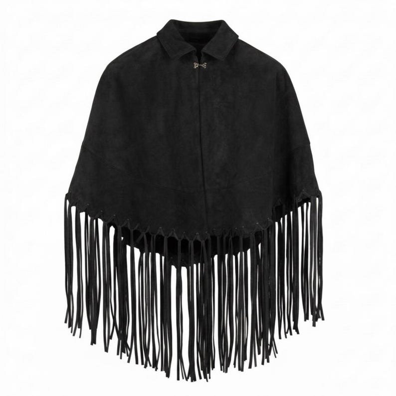 May include: A black suede poncho featuring a classic collar, a single silver-toned metal clasp closure at the neckline, and a wide hemline adorned with long, thin, matching black fringe detailing that hangs down from the bottom edge of the garment.
