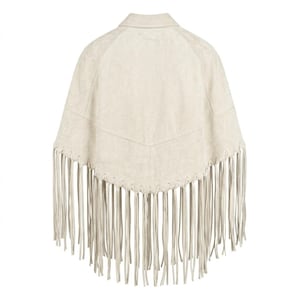 May include: A cream-colored poncho featuring a pointed hemline and long, thin fringe detailing along the bottom edge. The garment has a structured collar and a V-shaped seam across the upper back, showcasing a smooth, suede-like texture throughout.