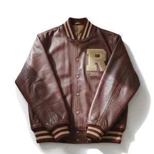 May include: A brown leather varsity jacket with a beige "R" patch and the year "1958". The jacket has a striped collar, cuffs, and waistband. The jacket is buttoned up and has a classic, vintage style.