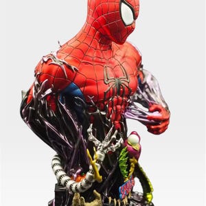 May include: A detailed bust of Spider-Man in a red and black suit, with a black spider emblem on the chest. The figure is partially engulfed in a dark, swirling substance, with mechanical arms and other elements at the base. The bust is a collectible item.