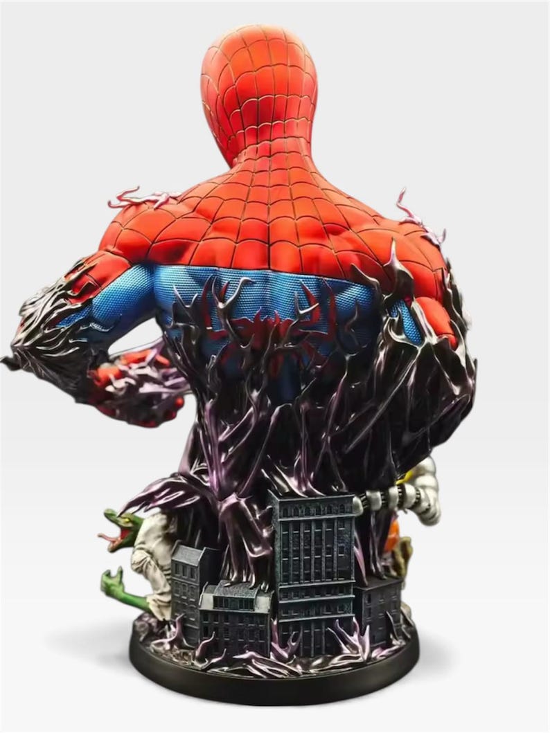 May include: A detailed Spider-Man bust statue, viewed from the back, showcasing the character's red and blue suit with intricate web detailing. The statue features a black, textured base with miniature buildings and figures, and a dark, organic design element.