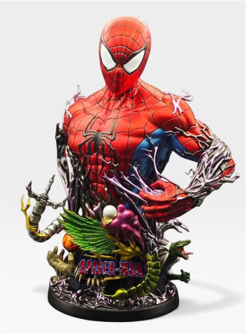 May include: A detailed Spider-Man bust statue in red and blue, with a black spider emblem on the chest. The statue features intricate detailing, including a base with various villain elements and the words "Spider-Man".