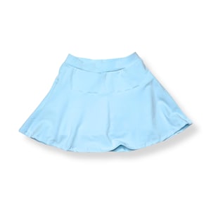 May include: A light blue flared skirt. The skirt has a wide waistband and a flowing, A-line silhouette. The fabric appears to be a smooth, lightweight material. The skirt is designed for casual wear.