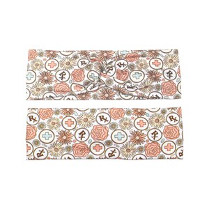May include: Two headbands with a floral pattern featuring flowers, crosses, and Rx symbols in peach, tan, and light blue on a white background. The top headband is twisted, and the bottom one is flat.