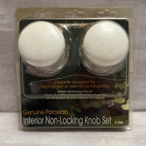 May include: A package containing two white porcelain interior non-locking door knobs. The package is labeled "Genuine Porcelain Interior Non-Locking Knob Set" and is designed for replacement or new home installation.