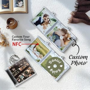 May include: Clear plastic CD cases with custom photos and text. One case has a CD with the names "Daniel" and "Kathy". The text "Custom Your Favorite Song" and "NFC" are also visible.