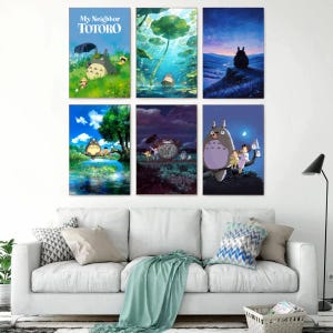 May include: Six framed art prints featuring scenes from the animated film "My Neighbor Totoro." The prints depict Totoro in various settings, including a forest, a pond, and under a starry night sky. The color palette includes blues, greens, and purples.
