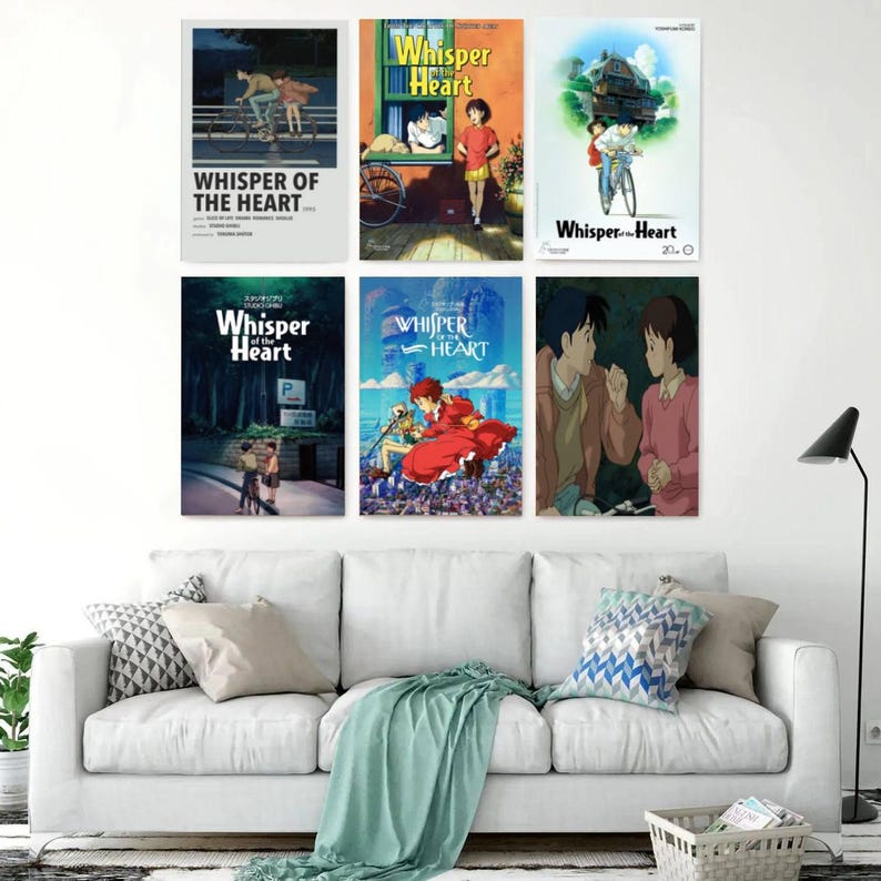 May include: Six framed movie posters from the animated film "Whisper of the Heart" are displayed on a white wall. The posters feature colorful illustrations of characters and scenes from the movie, with the title prominently displayed.
