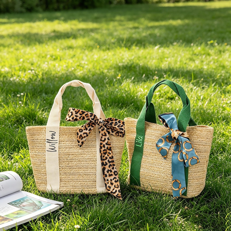 May include: Two woven straw tote bags with handles and decorative bows. One bag has a cream-colored handle and a leopard print bow, the other has a green handle and a blue patterned bow. The word "Willow" is printed on the first bag and "Lila" on the second.