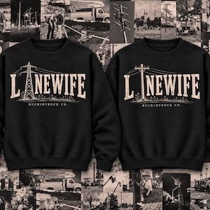 May include: Two black crewneck sweatshirts featuring a graphic print in a distressed beige tone. The left sweatshirt displays the text LINEWIFE with an electrical tower, while the right shows the same text with a utility pole. Both include BUCKIDTRUCK CO.