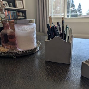 May include: A rustic wooden sign with the text "Welcome to our home" in white lettering. The sign features a distressed finish and a simple, inviting design, perfect for a front porch or entryway.