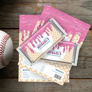 May include: A baseball and party favors. The favors are chocolate bars with pink icing and sprinkles, and the text "THANK YOU FOR COMING TO MICHAEL'S 12TH BIRTHDAY". The background is a wooden surface.