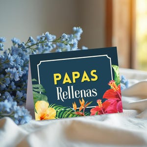 May include: A greeting card with the words "PAPAS Rellenas" in yellow text on a dark blue background. The card is decorated with watercolor illustrations of tropical flowers and foliage, including red and yellow hibiscus.