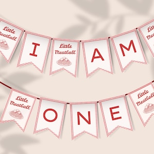 May include: A festive banner with red and white pennants spelling "I AM ONE." Each pennant has a red gingham border and features the words "Little Meatball" and an illustration of meatballs. The banner is strung on a red cord.
