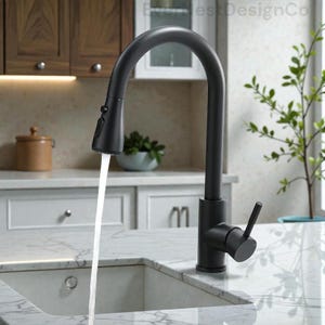 May include: A black kitchen tap with a curved spout. Water flows from the tap into a white sink. The tap has a single-handle lever and a pull-down sprayer. The background includes a white countertop and wooden cabinets.