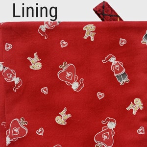 Layered with cotton batting and lined with Santa girls and boys, hearts on red.