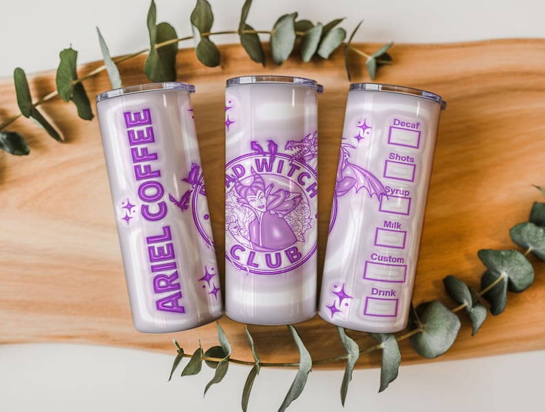 May include: Three insulated tumblers with purple and white designs. One tumbler reads "ARIEL COFFEE", another features a "BAD WITCH CLUB" logo, and the third has a coffee order form. The tumblers are decorated with stars and dragon illustrations.