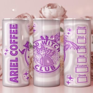 May include: A cylindrical tumbler with a purple and white design. The tumbler features the text "ARIEL COFFEE" vertically, and the words "BAD WITCH CLUB" with a witch illustration. The other side has a coffee order form.